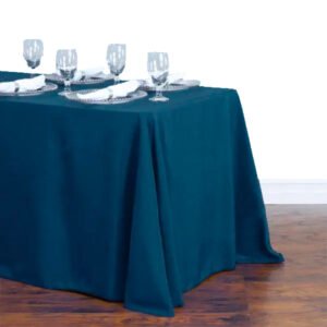 90 x 156 inch navy blue polyester tablecloth draped over a long banquet table at a wedding reception